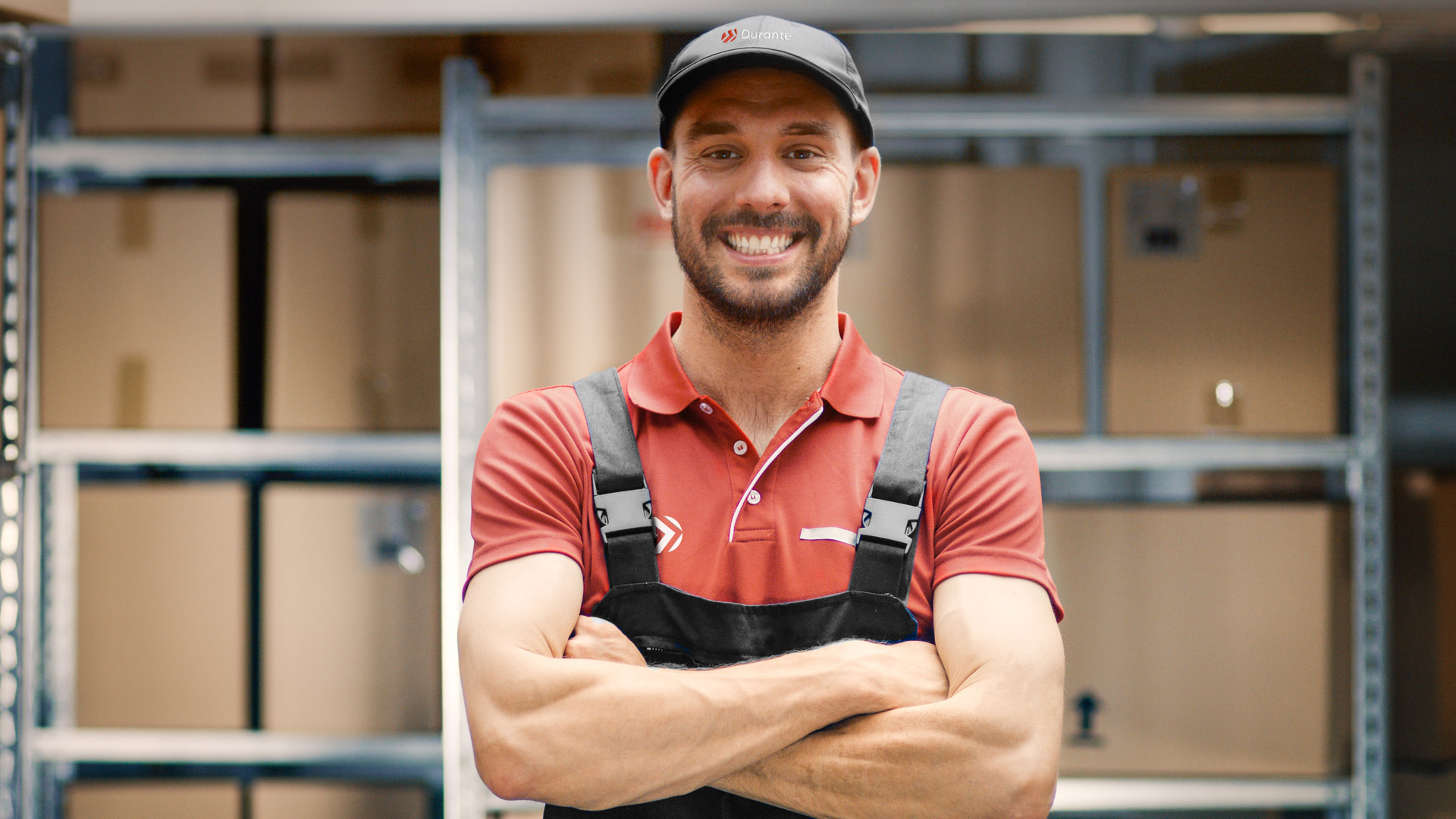 Warehouse Worker Crosses Arms and Smiles.