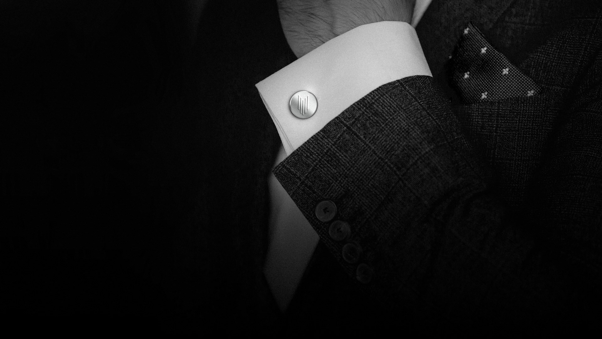 Hand men wears cufflinks close up.